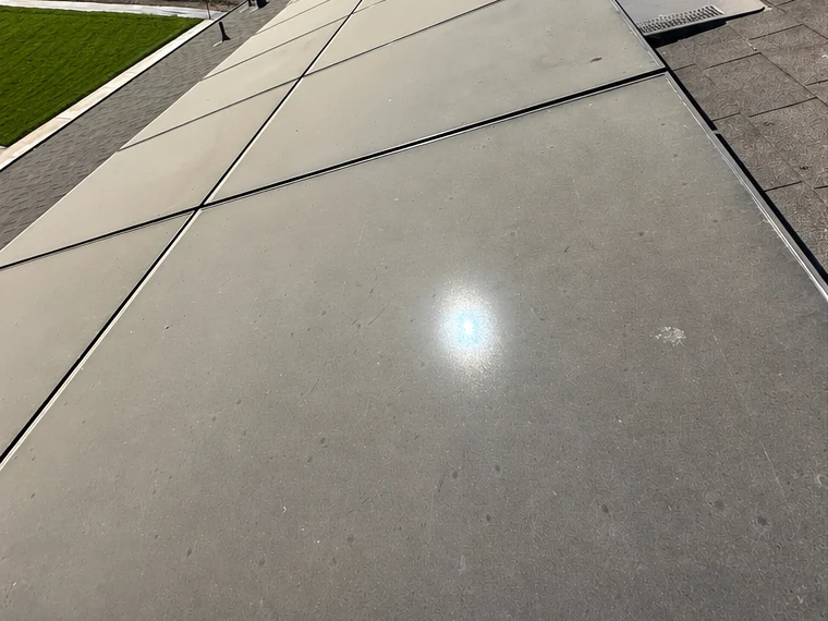 Before: a rooftop solar array dulled grey by Central Valley dust