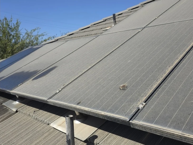 Before: a dusty solar array seen from the side