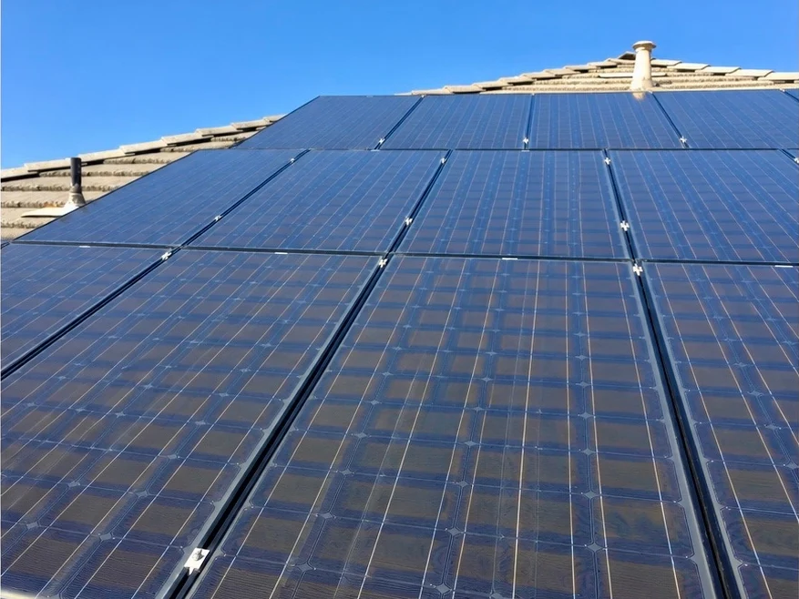 After: a tile-roof solar array coated in dust with bird droppings